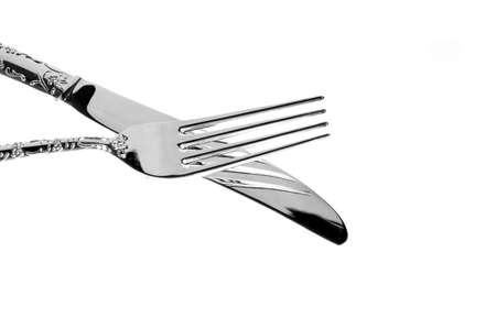 fork lying on the knife on the whiteの写真素材