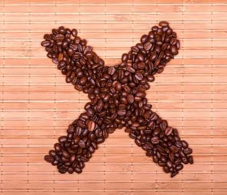  cross of coffee beans on a decorative strawの写真素材