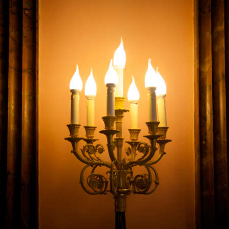 vintage candlestick lamp glowing gold platedの写真素材