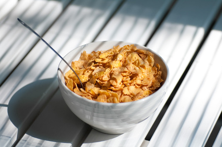 making a bowl of cornflakes and a spoonの写真素材