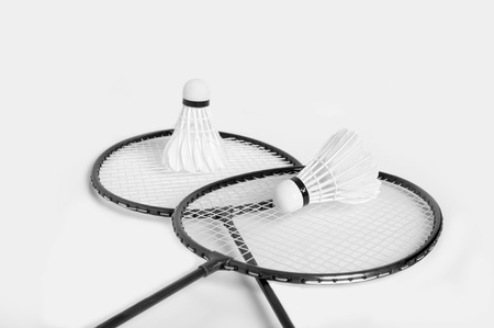 badminton rackets and shuttlecock in monochrome