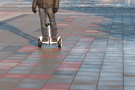 man riding a segway down the street