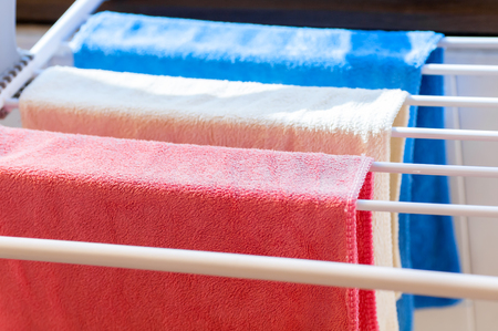 three colored towels on the dryer close-up
