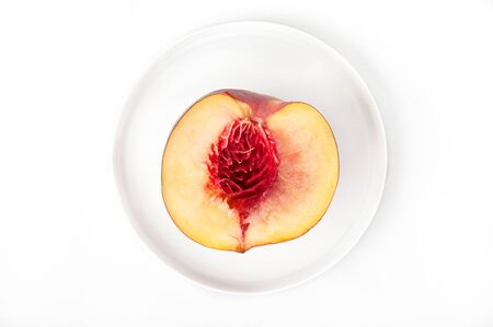 nectarine half on a white grater, without stones, isolate, top viewの写真素材