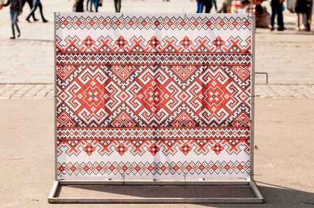 road barrier dressed up with a canvas with embroidery elements of Ukraineの写真素材
