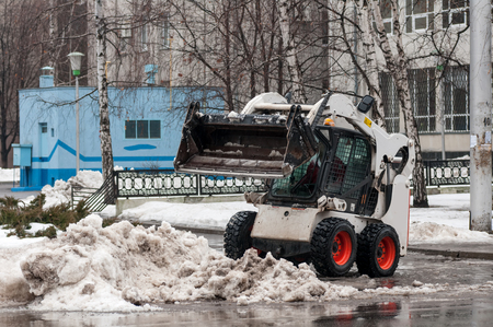 snow cleaning machine on the streets of the city in winterの写真素材