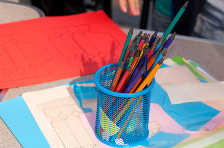 Color pencils in a glass during the creative lesson are on the tableの写真素材