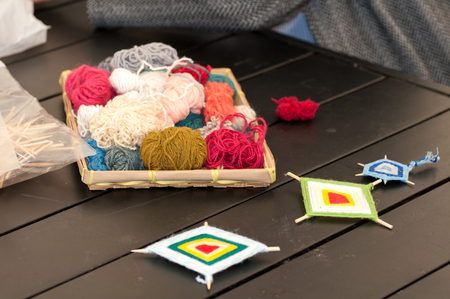  teacher teaches children how to weave a mandala out of thread during the fair in Ukraineの写真素材