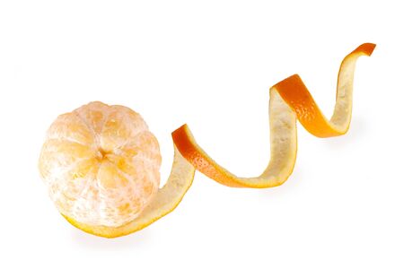 the peel lies in a spiral near the peeled orangeの写真素材
