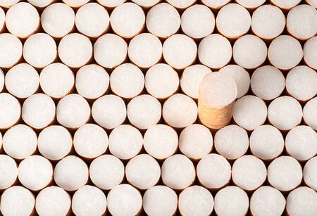 cigarette filters in a row background, close-up, top view
