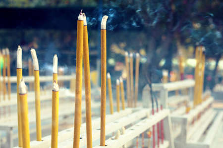 Fumigating yellow sticks in chinese templeの写真素材