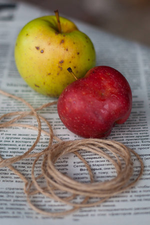 ripe apples in a garden on newspaper backgroundの写真素材