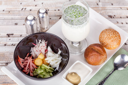 Russian soup Okroshka with bread on white tableの写真素材