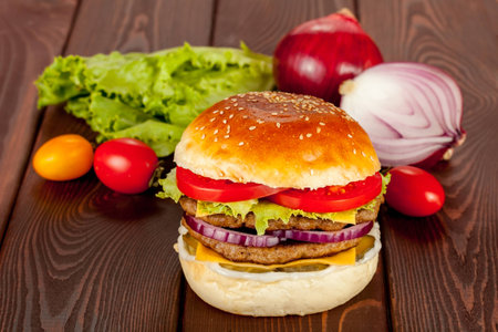 Double beef burger with ingridients on wood backgroundの写真素材