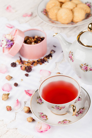 cup of red tea on white serving tableの写真素材