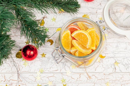 Christmas sweets under the tree on wood backgroundの写真素材