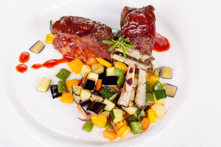 lamb chops with vegetables and sauceの写真素材