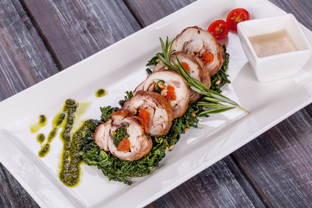 Chicken roulade with spinach, nuts and dried apricotsの写真素材
