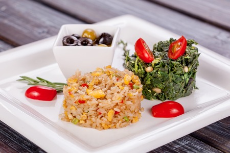 Vegetarian rice dish with vegetables and spinach stewed with nutsの写真素材