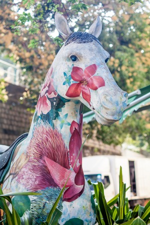 Art object on the street, painted horse close-up, with flowersの写真素材