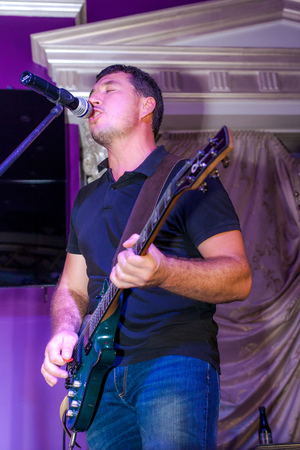 Musician plays guitar and sings on stage in neon light close upの写真素材