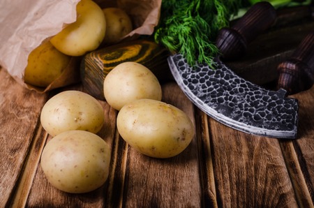 Fresh young potatoes on wooden backgroundの写真素材