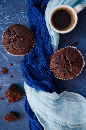 Chocolate cupcakes with a cup of hot black coffee. Selective focus. Top viewの写真素材