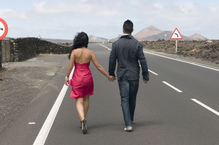 man and woman going away on the road