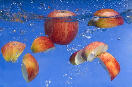 apple under water with a trail of transparent bubblesの写真素材