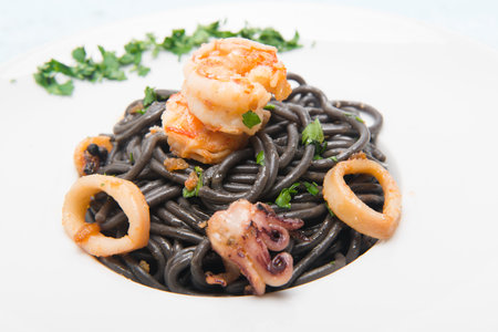 black spaghetti pasta dish with shrimp and seafoodの写真素材