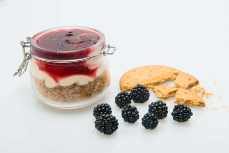 strawberry jam with yogurt in a glass jar
