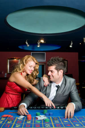 couple in love very happy in a casino for their fortune in gamblingの写真素材