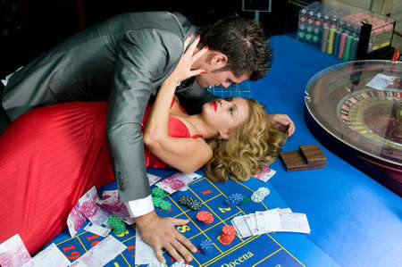 couple in love in a casino celebrating their good fortuneの写真素材