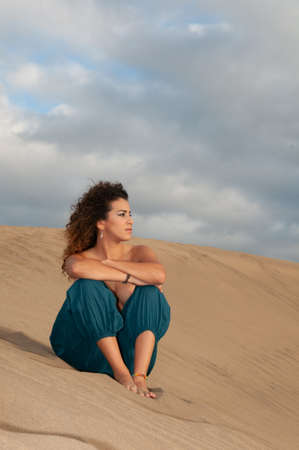 belly dancer in the desert at sunsetの写真素材