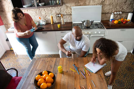 multiracial family in the kitchen of their home sharing moments togetherの写真素材