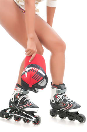Woman's legs on roller skates holding a cap