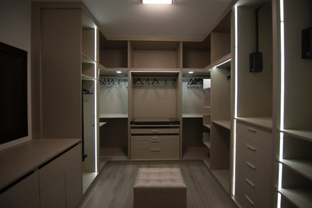 Closet room with plenty of space for clothes and shoes in a homeの写真素材