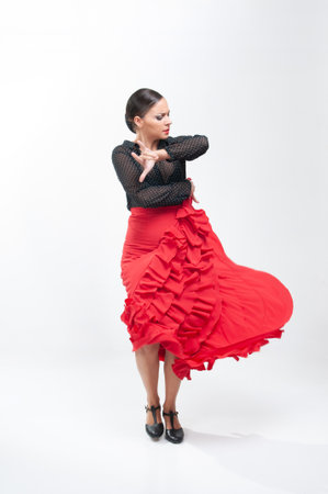 Full length portrait of a beautiful woman dancing flamenco isolated on white backgroundの写真素材