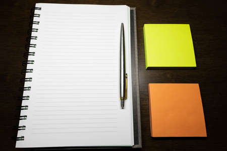 To write something on the notebook or the colorful stick noteの写真素材