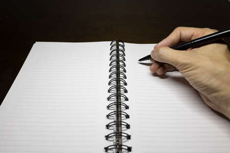 To write something on the notebook or the colorful stick noteの写真素材