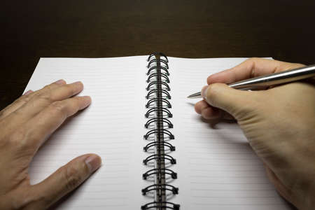 To write something on the notebook or the colorful stick noteの写真素材