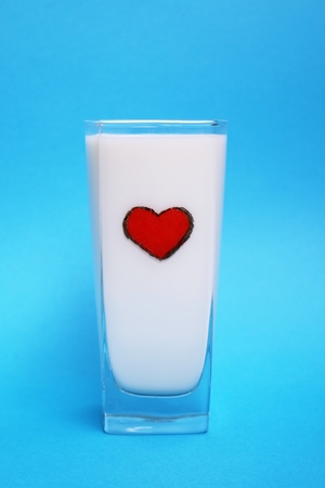 A glass of milk on blue background, Milk conceptの写真素材