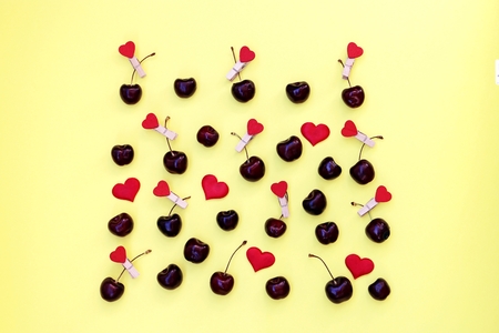 Fresh cherry berries on a yellow background