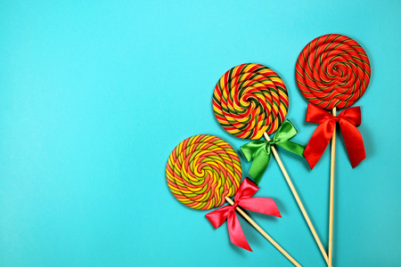 Colorful lollipops on blue backgroundの写真素材