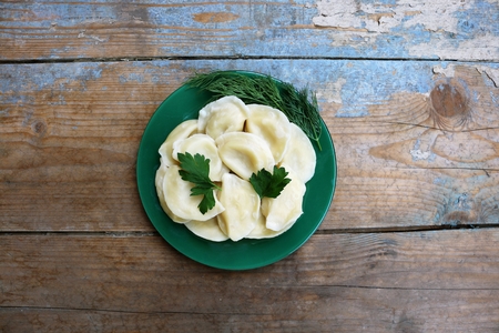 Boiled dumplings on a plate. Wooden rustic backgroundの写真素材