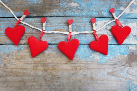 Red hearts on wooden background.Valentines day greeting card.Top view with copy spaceの写真素材