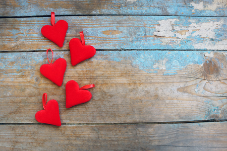 Red hearts on wooden background.Valentines day greeting card.Top view with copy spaceの写真素材