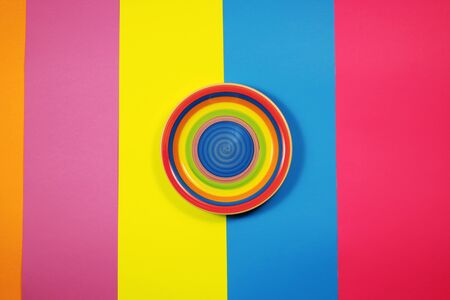 Bright Plate on multicolored background, top viewの写真素材