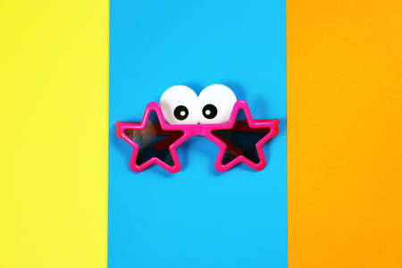 Star shaped sunglasses on multicolored backgroundの写真素材