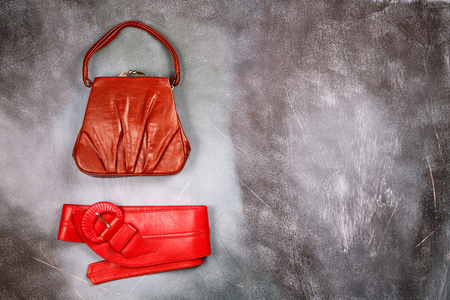 Red leather handbag and belt, retro styled, top viewの写真素材